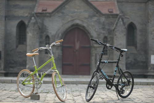 黑色自行车旁边的绿色自行车 · 免费素材图片