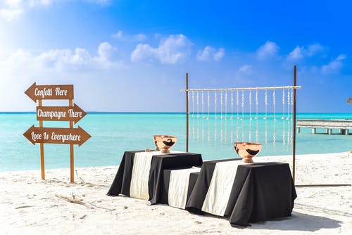 三张桌子，覆盖着黑色和白色的桌布，在海边 · 免费素材图片