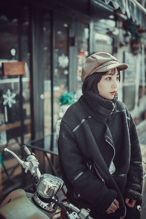 黑色外套坐在摩托车上的女人 · 免费素材图片