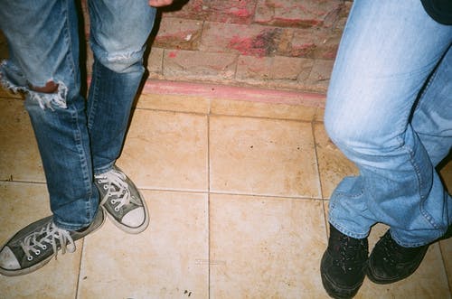 两人穿着蓝色牛仔裤和系带的鞋子 · 免费素材图片