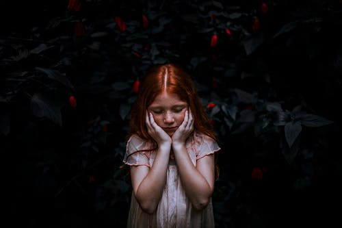 站在植物附近的红发女孩 · 免费素材图片