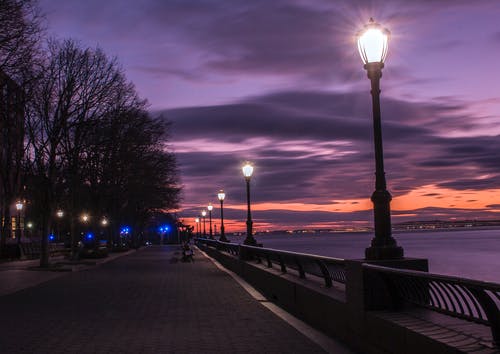 夜间在海湾旁打开路灯的摄影 · 免费素材图片