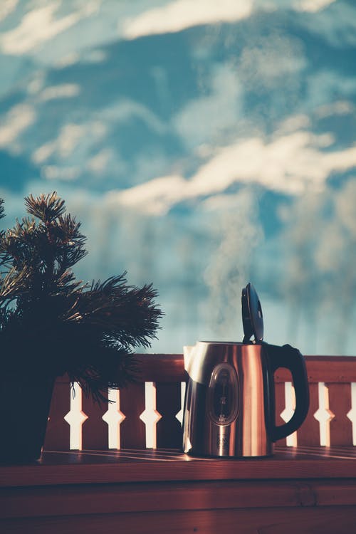 灰色的栏杆旁边的银电水壶的选择性聚焦摄影 · 免费素材图片