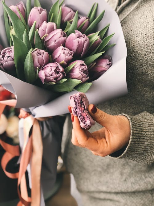 持有粉红色郁金香花束的人 · 免费素材图片