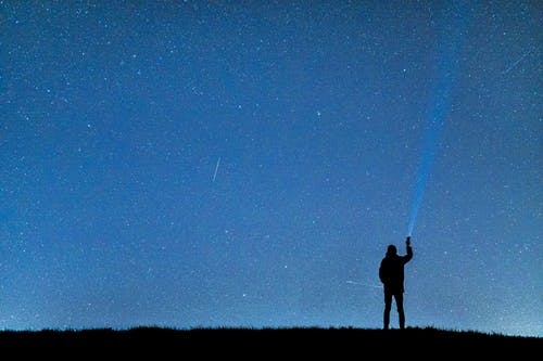 夜间在蓝蓝的天空下的人的轮廓 · 免费素材图片