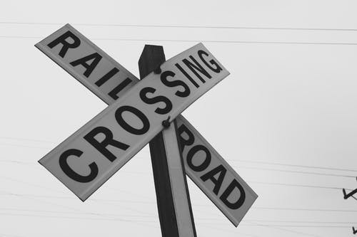 铁路道口标牌的灰度摄影 · 免费素材图片