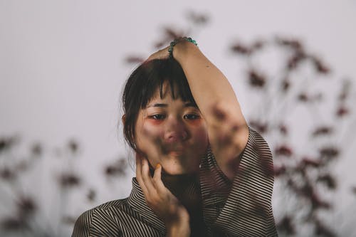 女人的选择性聚焦照片双手放在头上 · 免费素材图片