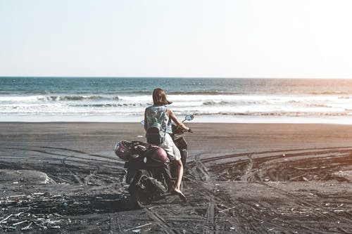 女人骑摩托车在海边 · 免费素材图片