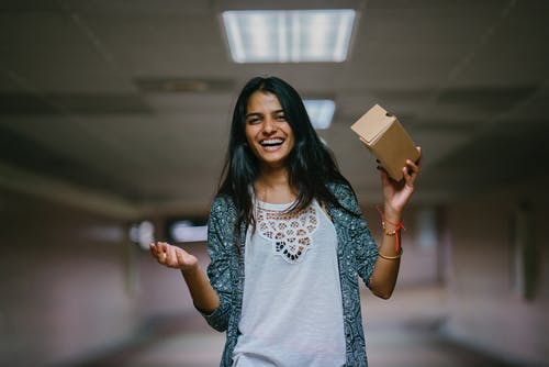 女人抱着棕色纸板箱 · 免费素材图片