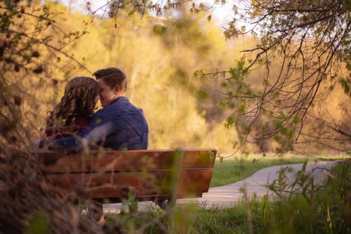 夫妇坐在长椅上的摄影 · 免费素材图片