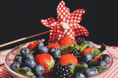 草莓和蓝浆果在玻璃圆板上 · 免费素材图片