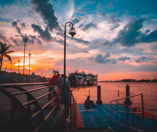 一群人在港口看日落 · 免费素材图片