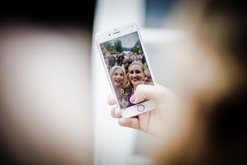 黄金iphone 6的选择性焦点照片，显示两名妇女正在拍照 · 免费素材图片