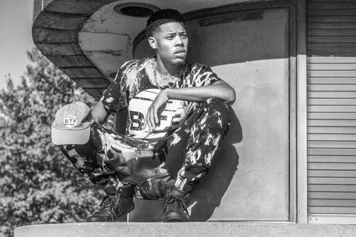 蹲姿男子的灰度摄影 · 免费素材图片