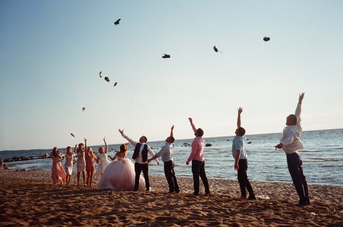 人们在海边扔东西 · 免费素材图片