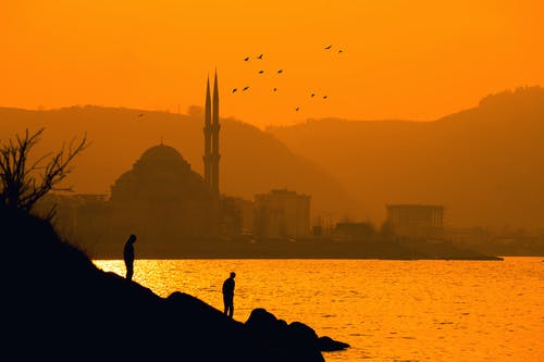 两人在遥远的奥尔塔科伊清真寺，伊斯坦布尔土耳其海附近的轮廓 · 免费素材图片