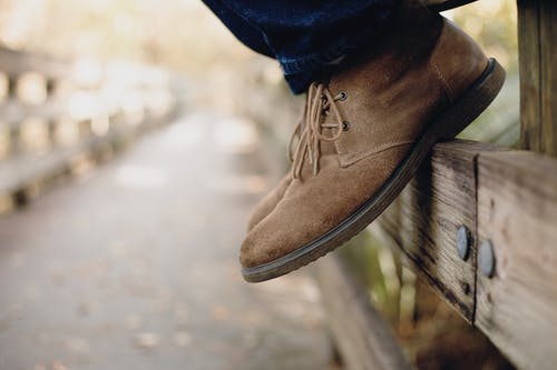 穿棕色靴子的人的特写照片 · 免费素材图片