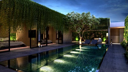 混凝土建筑与外面的游泳池和蓝蓝的天空下的绿叶树 · 免费素材图片