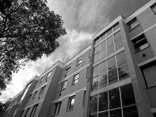 玻璃窗混凝土建筑的灰度摄影 · 免费素材图片