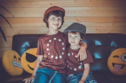 两个男孩坐在沙发上 · 免费素材图片