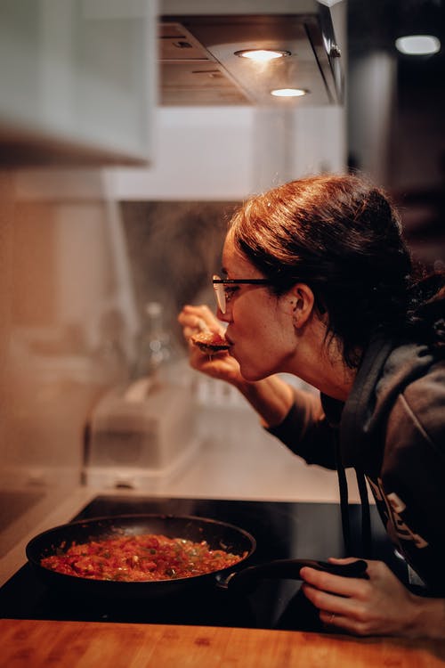 女人在烹饪锅上吃 · 免费素材图片