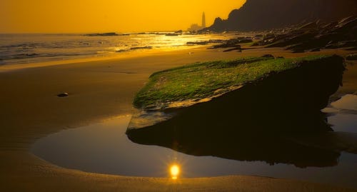 日落期间的海滨照片 · 免费素材图片