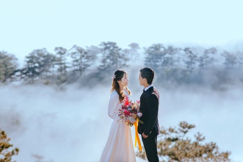 新娘和新郎的高角度照片与seaclouds背景 · 免费素材图片