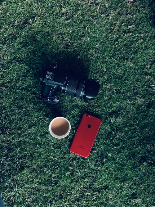 产品红色iphone 7旁的相机 · 免费素材图片