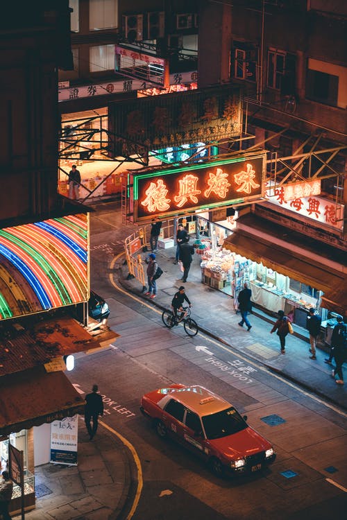 夜间在带有中国标志的街道上行走的人的航拍 · 免费素材图片