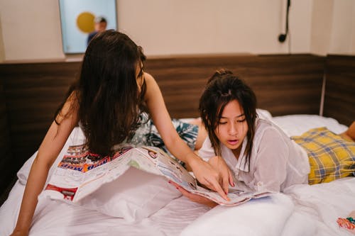 看着纸躺在床上的两个女人 · 免费素材图片