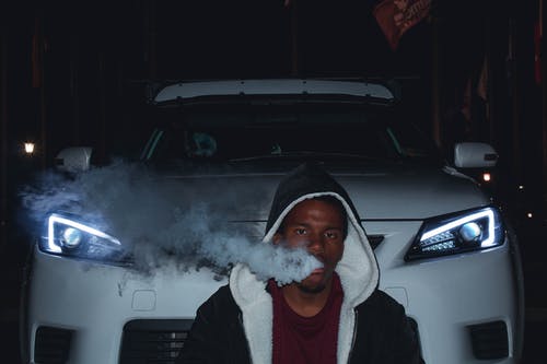 在车前吸烟的男子的照片 · 免费素材图片