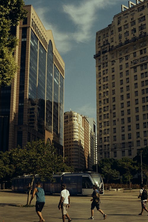 白天在火车附近的人行道上行走的人 · 免费素材图片