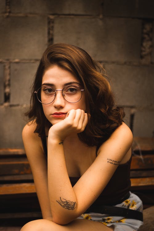 女人坐着放让手在脸上 · 免费素材图片