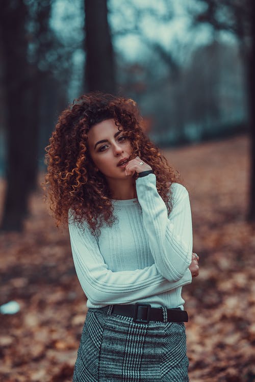 白色上衣和灰色和黑色格子裙摆姿势的常设女人照片 · 免费素材图片