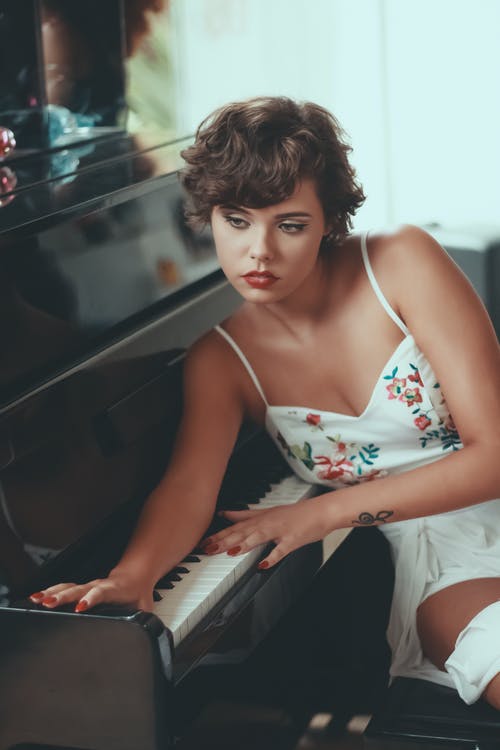女人靠钢琴键 · 免费素材图片