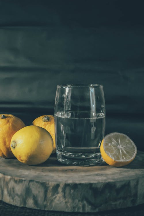 柠檬旁边的水杯照片 · 免费素材图片