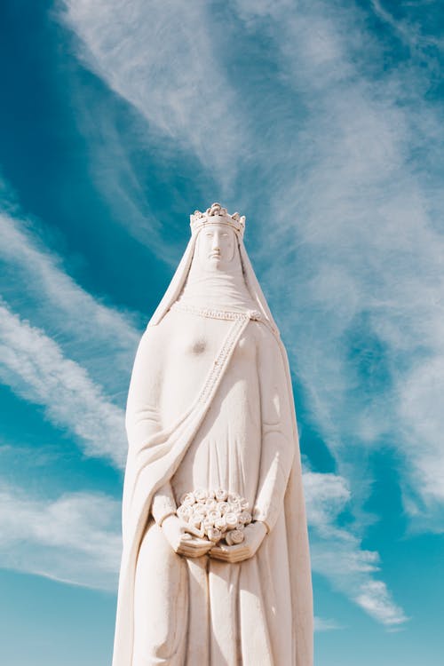 女人混凝土雕像在晴朗的天空下 · 免费素材图片