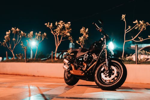 黑色摩托车停在人行道上的照片 · 免费素材图片