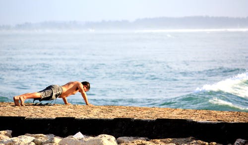 男人做推在海边 · 免费素材图片
