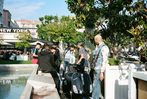 站在黑色摩托车旁边的人 · 免费素材图片