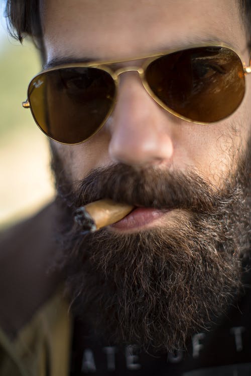 男子吸烟雪茄的特写照片 · 免费素材图片