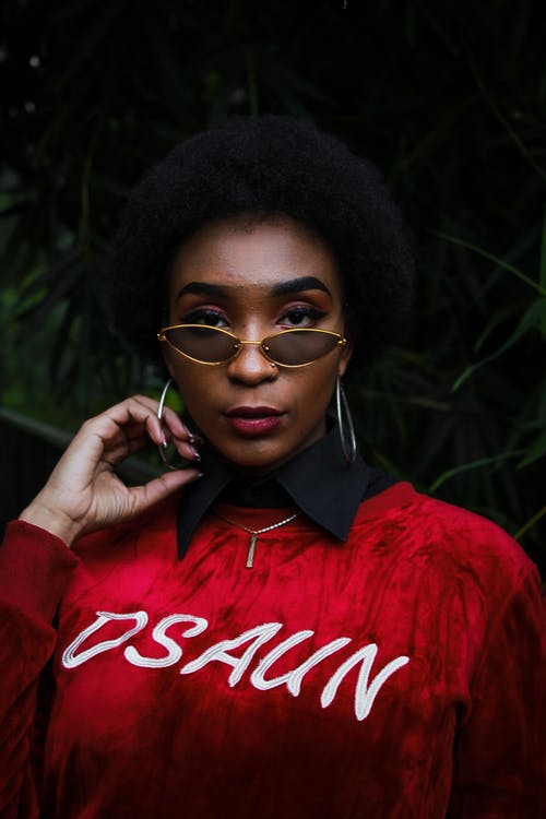 穿红色毛衣和太阳镜的女人的照片 · 免费素材图片