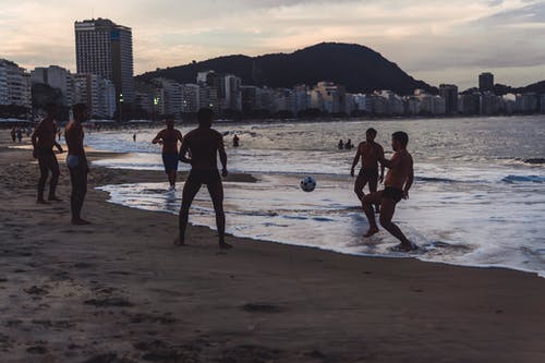 男子在海边打球 · 免费素材图片