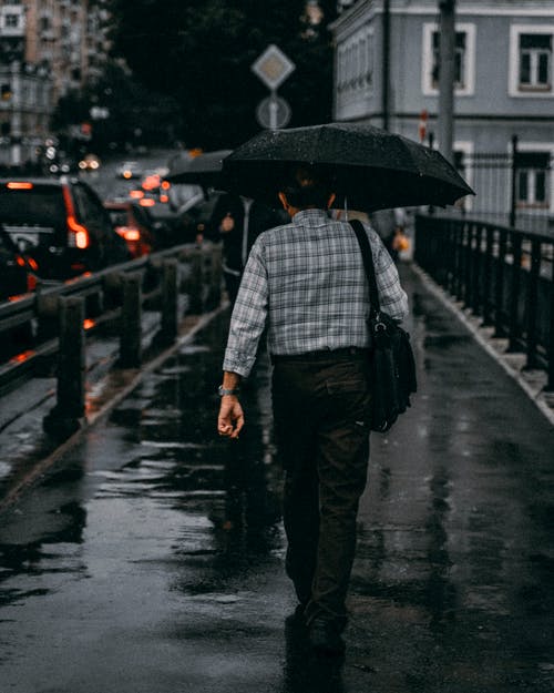 男子走着伞 · 免费素材图片