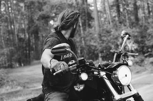 男子骑着黑色的摩托车，在灰度摄影 · 免费素材图片