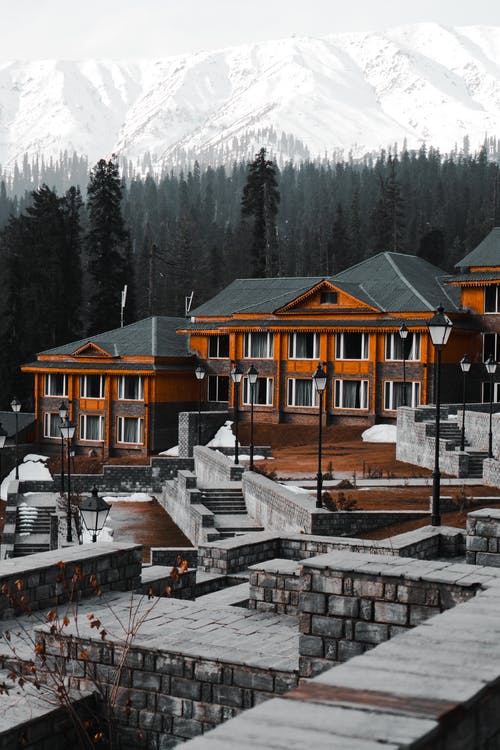 横跨白山的橙色和灰色房屋 · 免费素材图片
