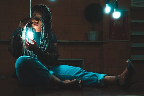 女人抱着灯泡的照片 · 免费素材图片