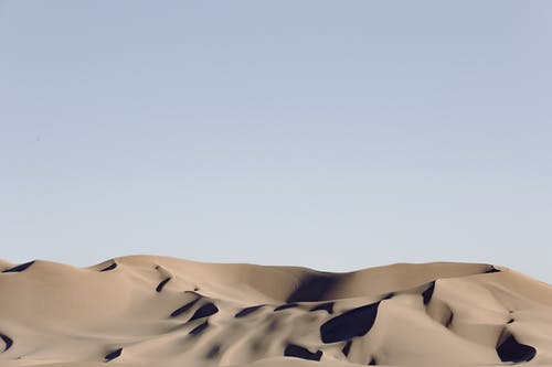 蓝天下的灰色沙漠 · 免费素材图片