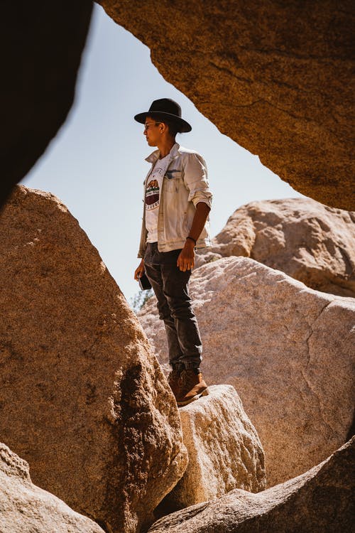 男子站在岩石上 · 免费素材图片