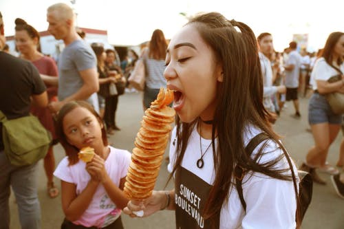 女孩吃串食物 · 免费素材图片